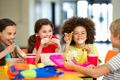 Happy Kids Eating a health lunch