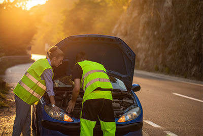 A car on the side of the road with the hood open