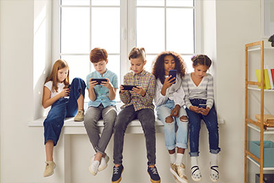 a group of kids on cell phones