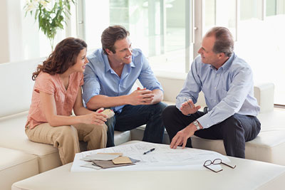 three people discussing construction plans