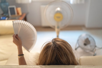 a woman in her home with two fans