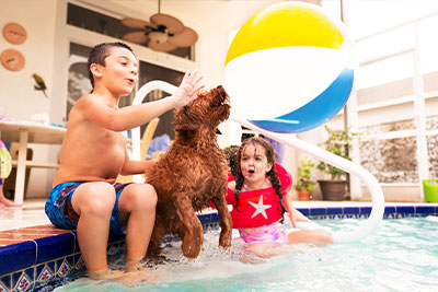 Kids with a dog at their pool