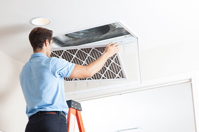 handyman inspecting hvac vent